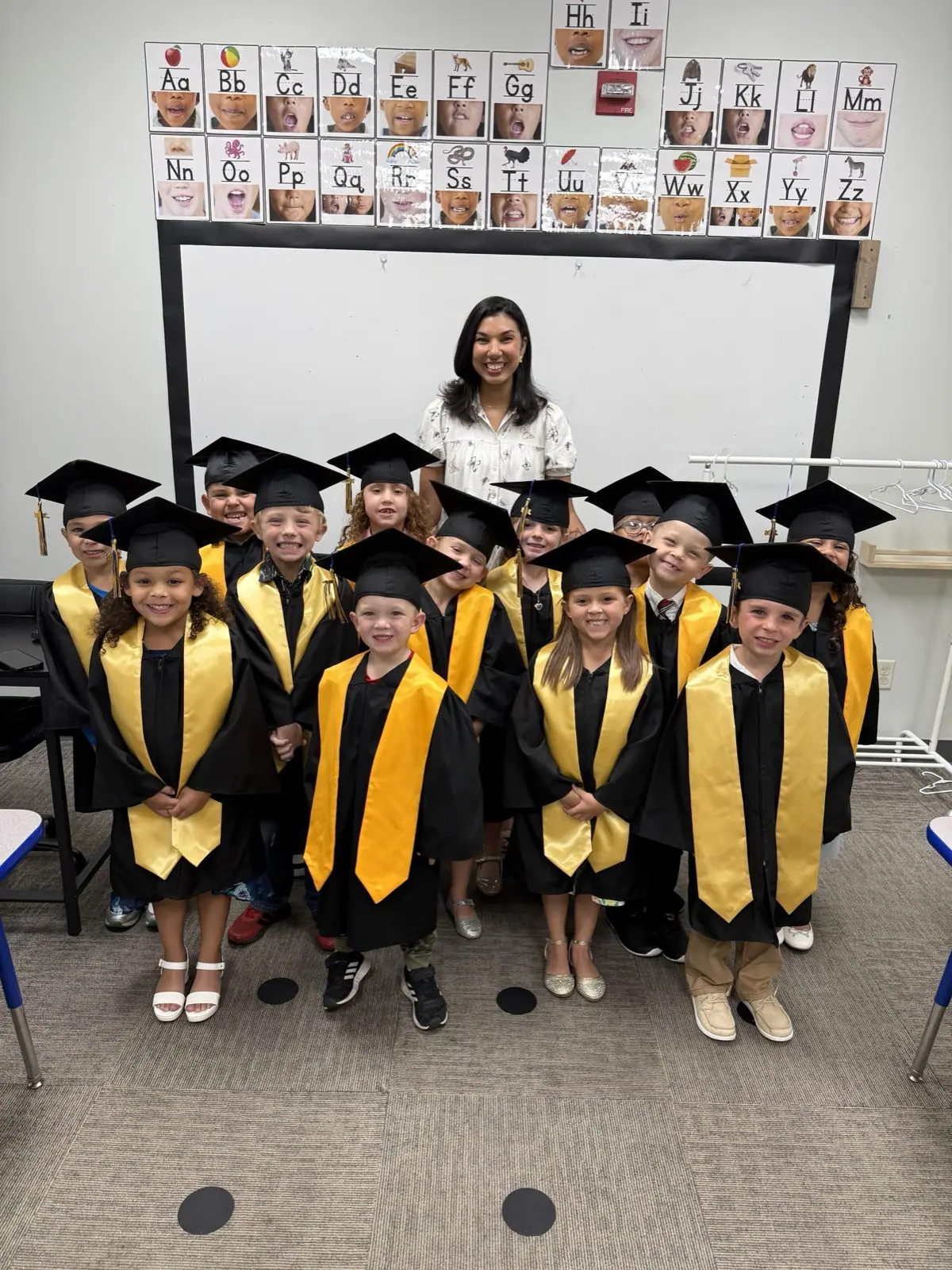 Kindergarten graduates in caps and gowns