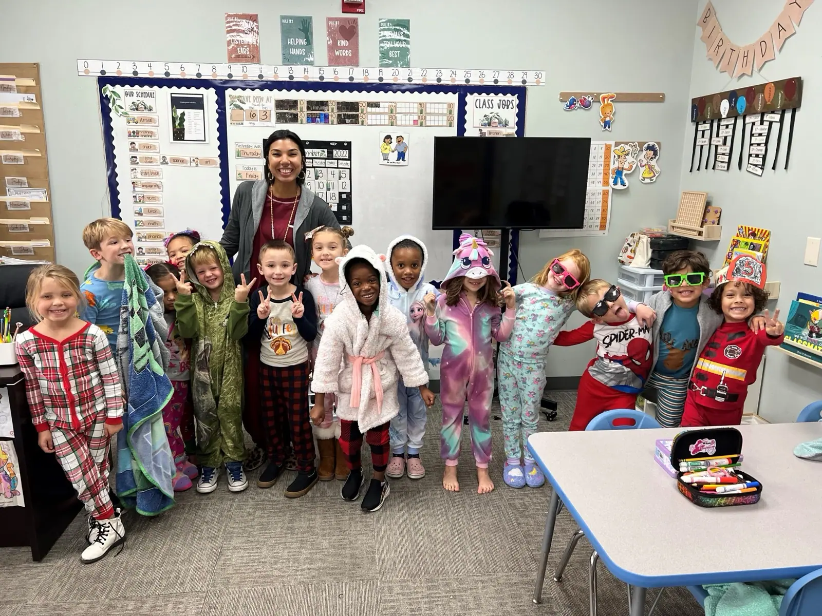 A Rock Academy class in pajamas with their teacher on spirit day