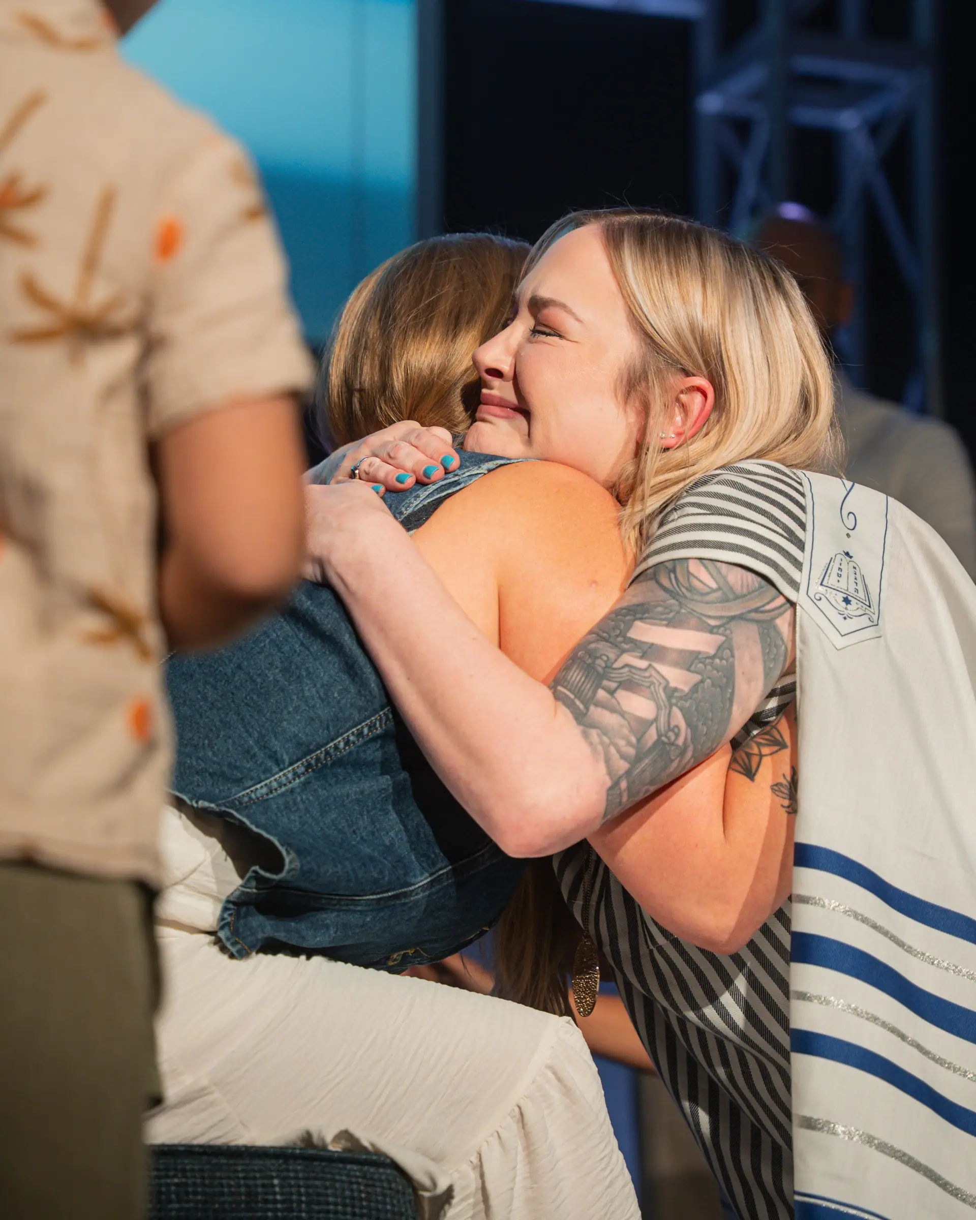 Two friends hugging after Sunday service