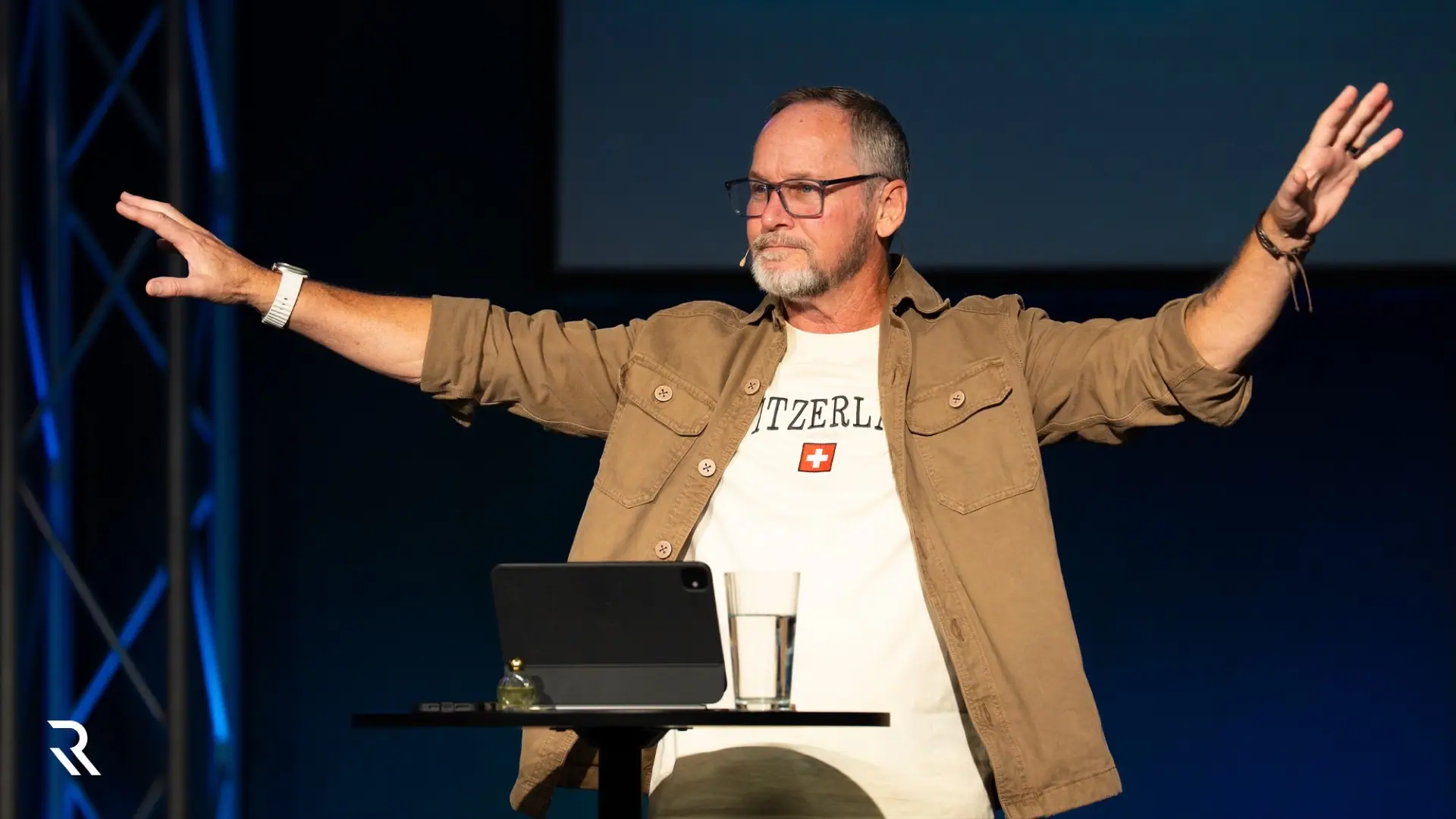 Pastor Steve Parker preaching with his arms open wide